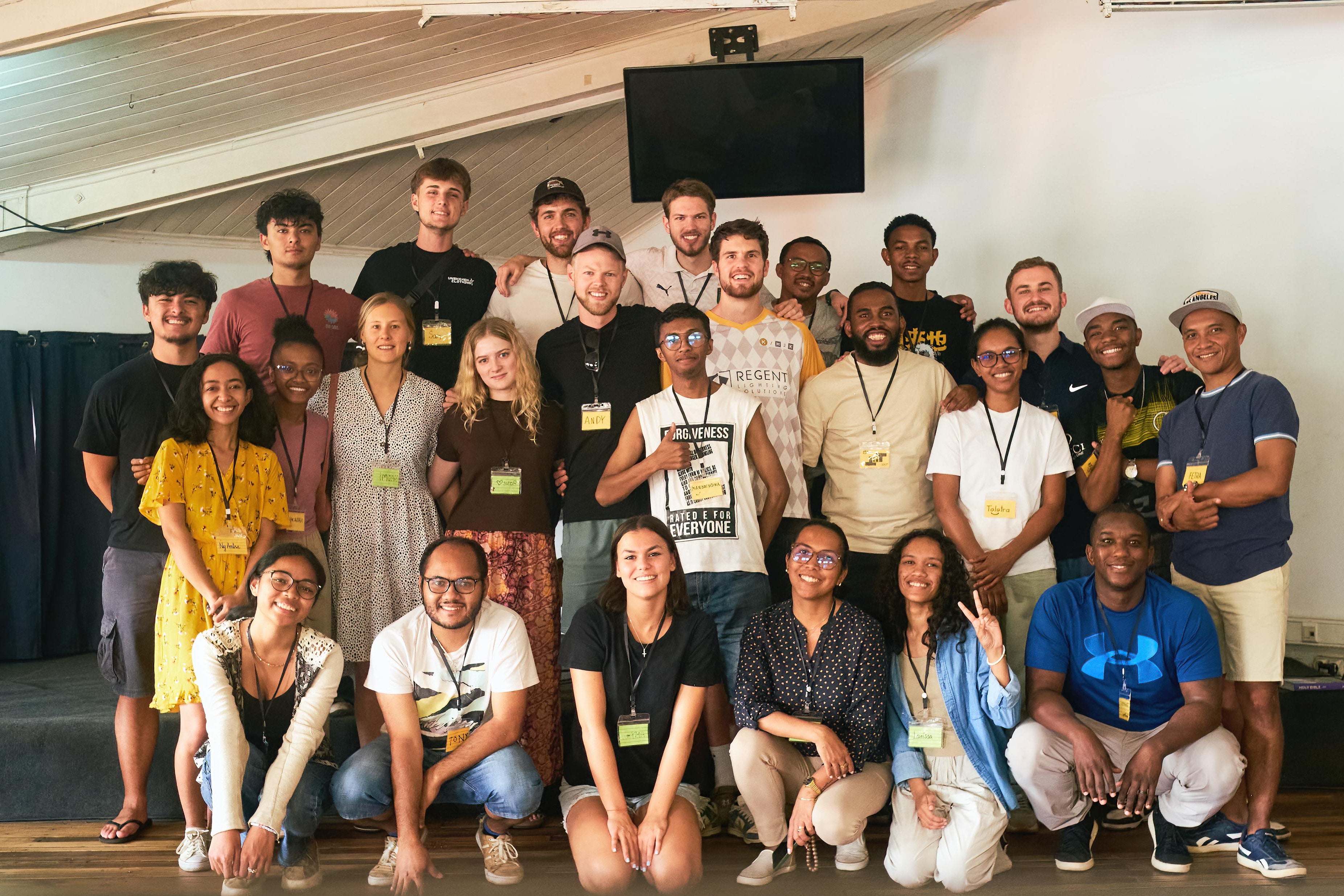 Group of people posing for a photo in an indoor setting